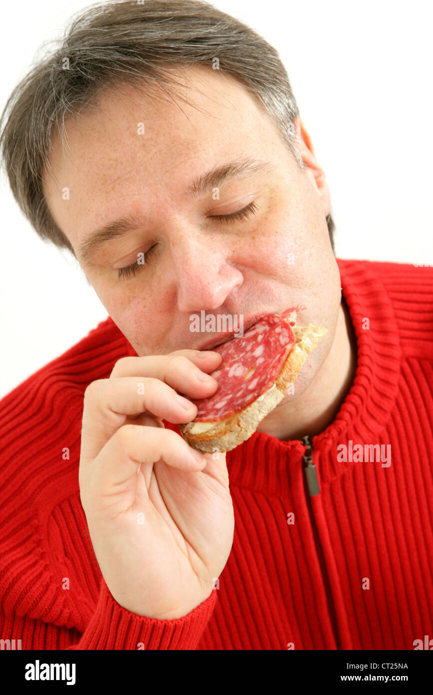 MAN EATING PORK MEAT Stock Photo Alamy