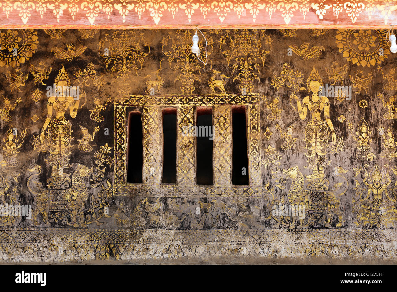 old golden paintings on Vat Xieng Thong temple wall, Luang prabang, Laos Stock Photo