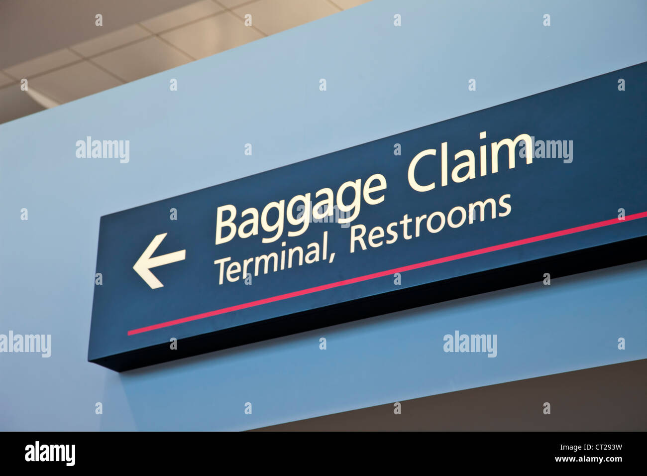 baggage claim, terminal, restrooms - airport sign with arrow Stock Photo