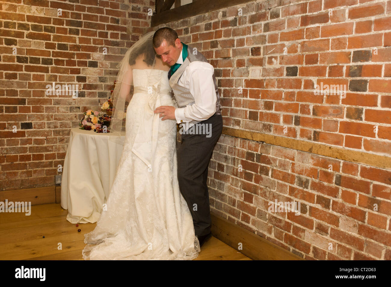 Bride and groom with their sponge cake during reception after a civil ...