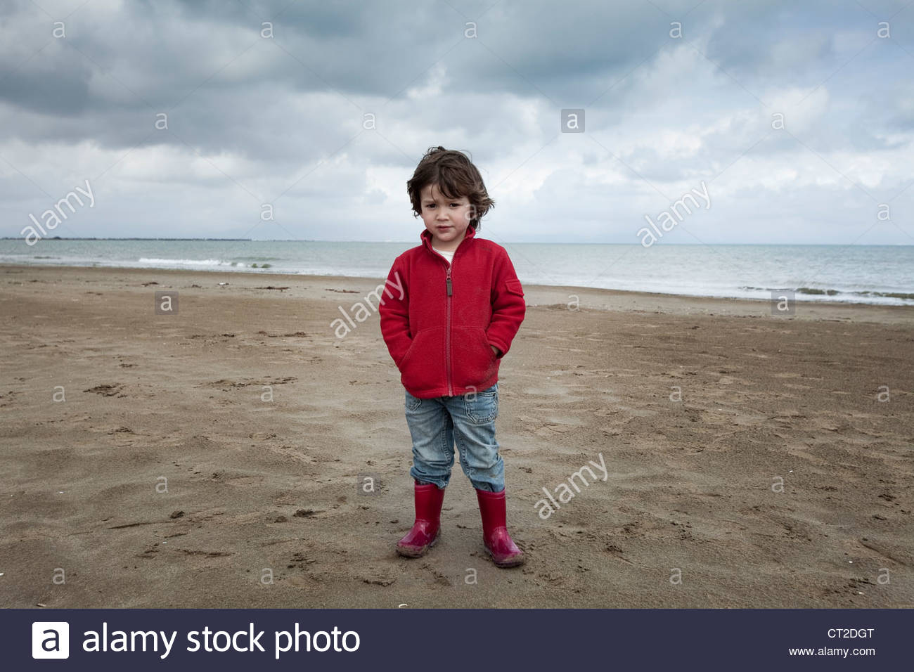 red rain boots on the beach Stock Photo 
