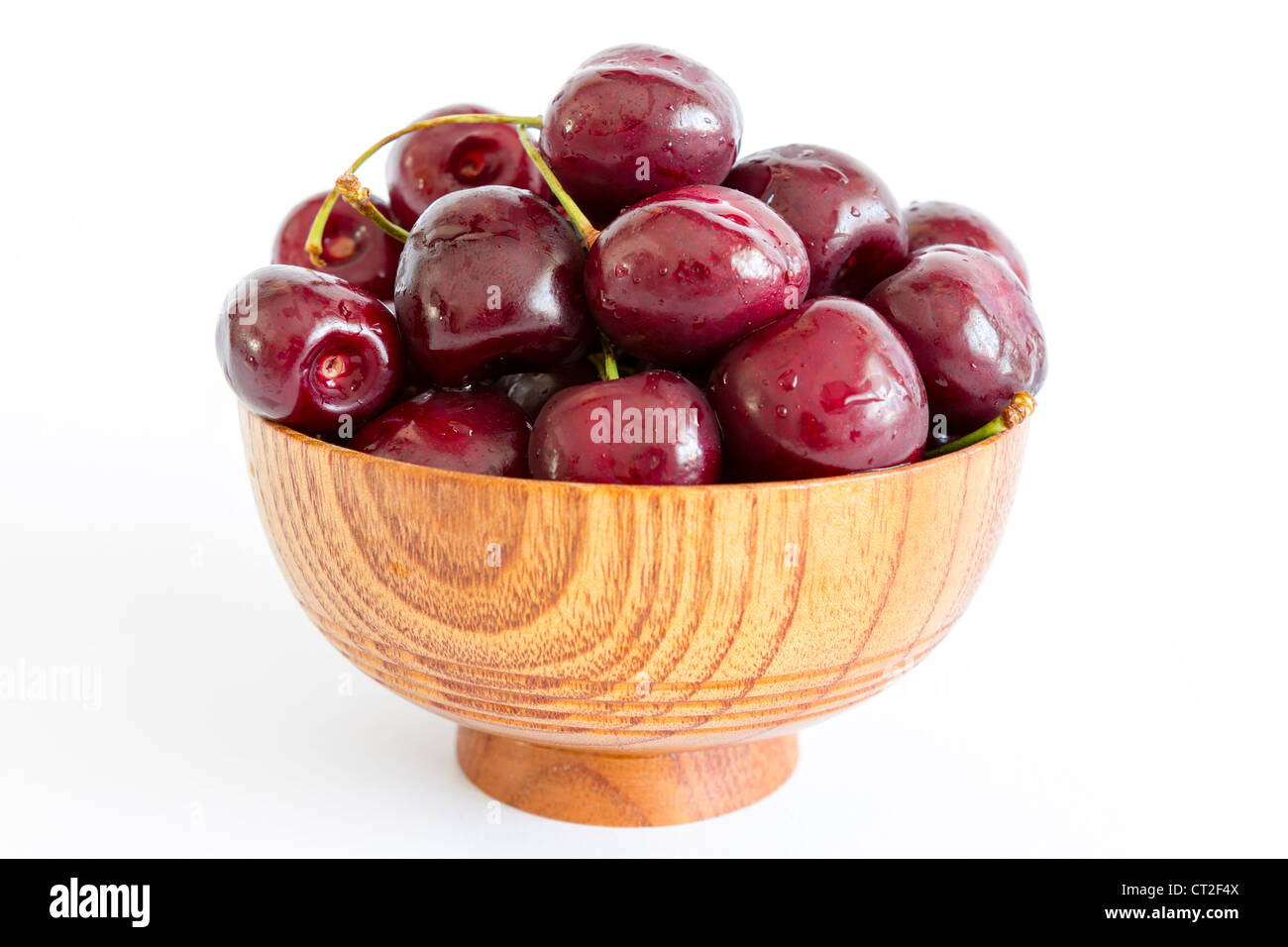 Cherry in wooden bowl isolated on white background Stock Photo