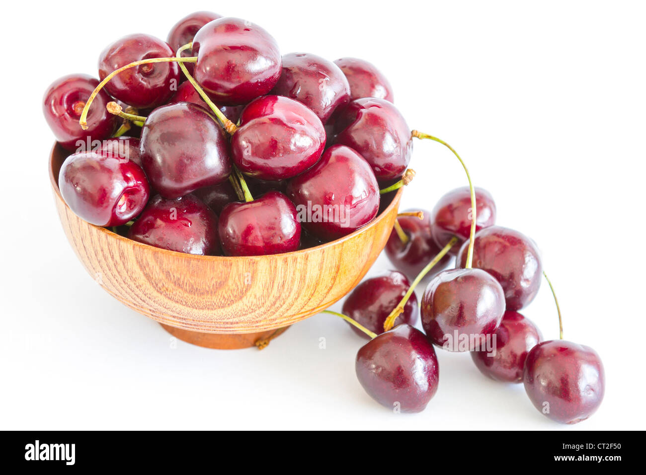 Cherry in wooden bowl isolated on white background Stock Photo