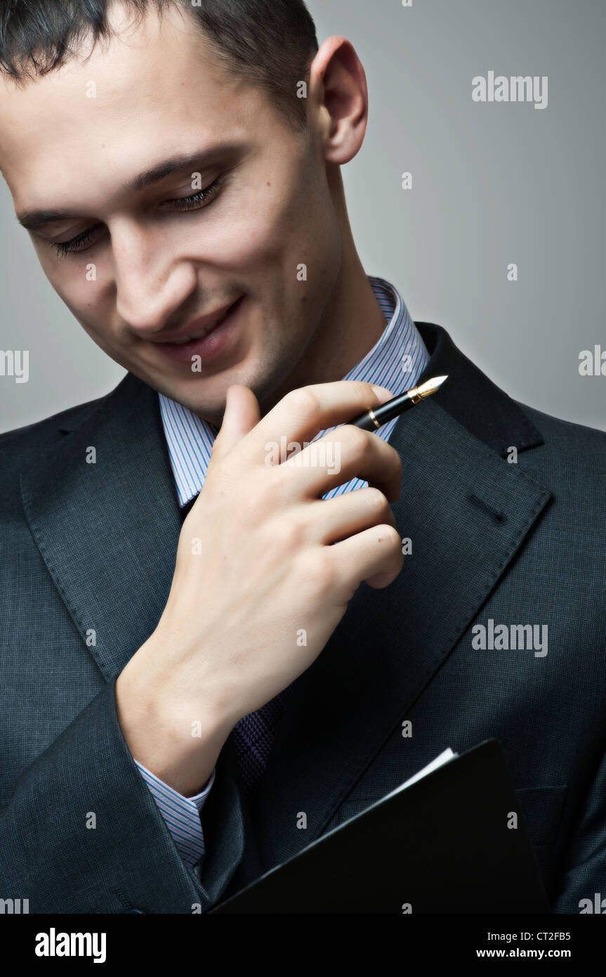 portrait of smiling businessman with pen and paper Stock Photo - Alamy