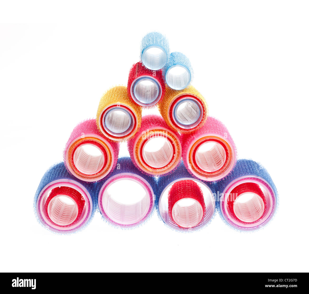 Colorful hair rollers stacked in pyramid isolated on white background Stock Photo