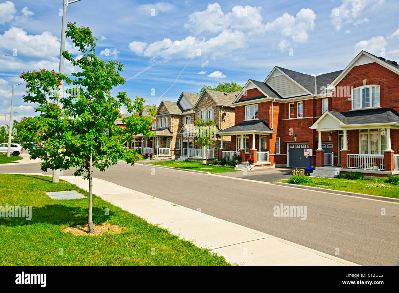 Suburban residential street with red brick houses Stock Photo