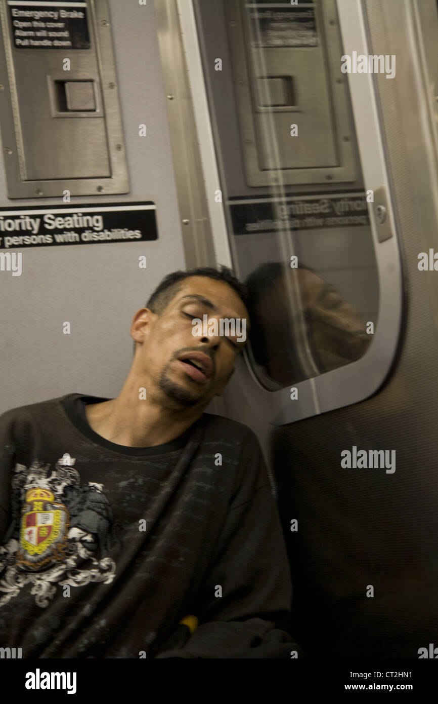 Man asleep on a subway train in Brooklyn, NY Stock Photo - Alamy