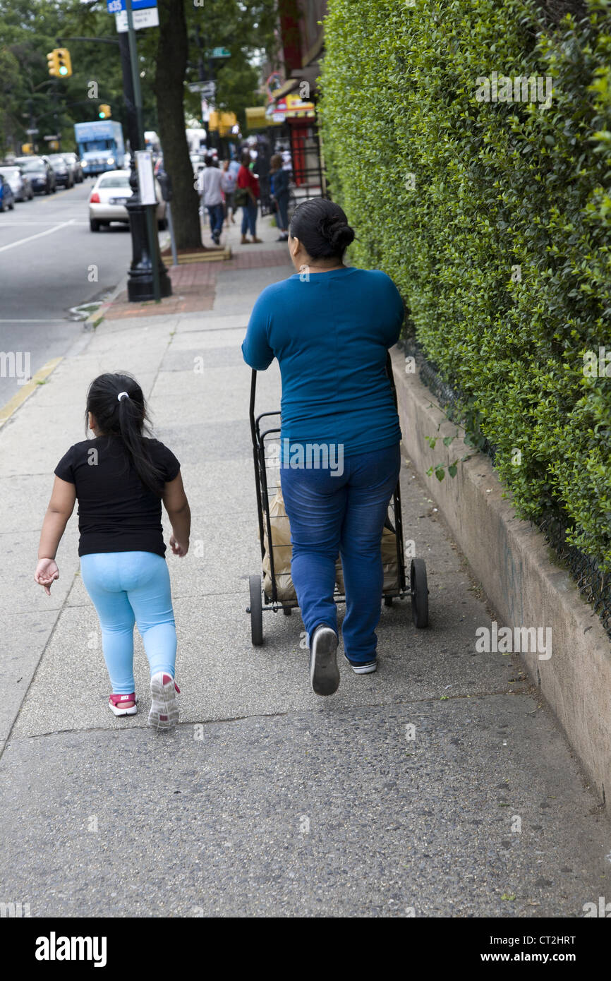 mexican-woman-and-daughter-walk-down-a-street-in-brooklyn-ny-displaying-CT2HRT.jpg