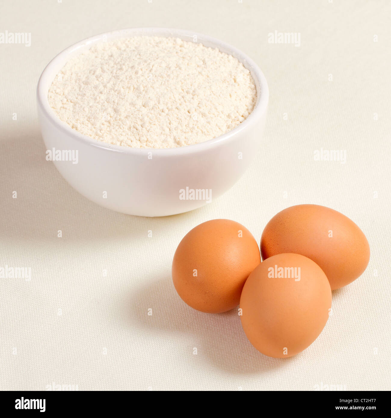 Eggs and wheat flour in a plate on white background Stock Photo Alamy