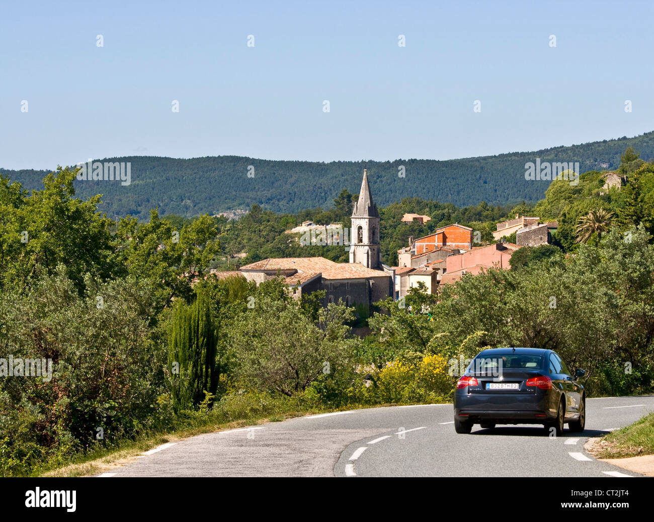 Car on road above hilltop French village of Callas Provence Var France