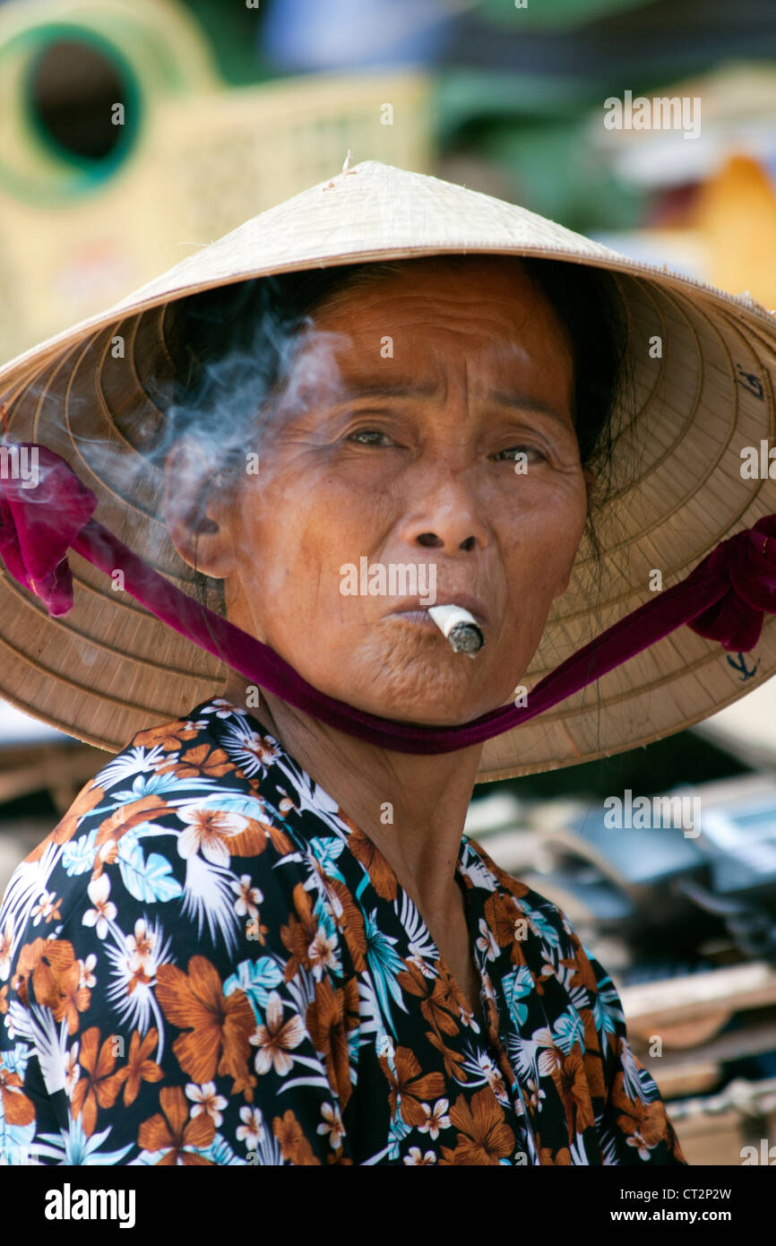 WOman smoking on market stall, Hue, Vietnam Stock Photo Alamy