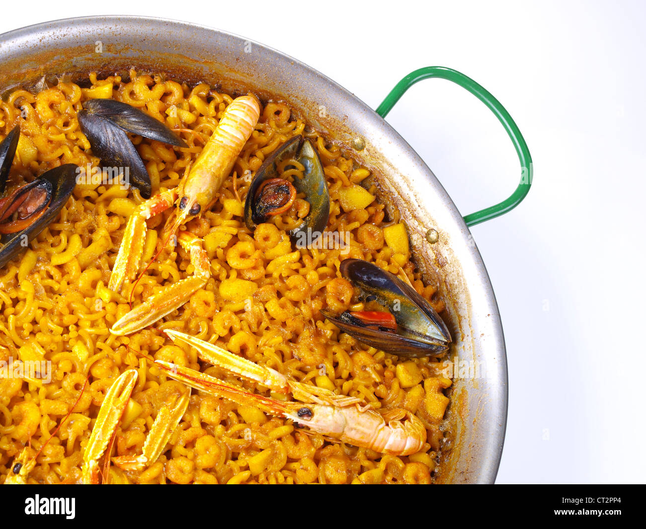 Fideua – Noodle paella. The “Fideua” is a kind of seafood paella, but replacing the rice per a kind of thick short noodles. Stock Photo