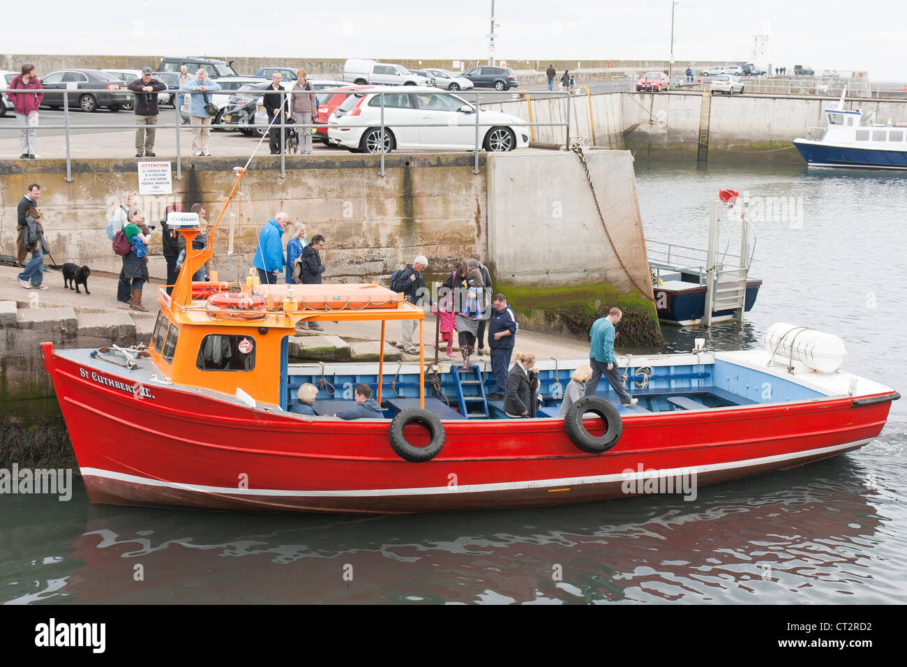 Seahouses Harbour with a boat for the Farne Islands Stock Photo - Alamy