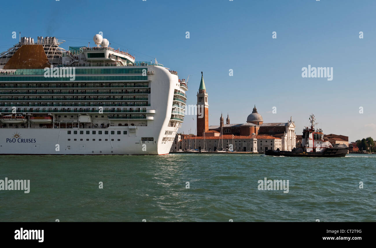 The huge P&O cruise ship MV Ventura is towed past the church of San Giorgio Maggiore in Venice, Italy Stock Photo