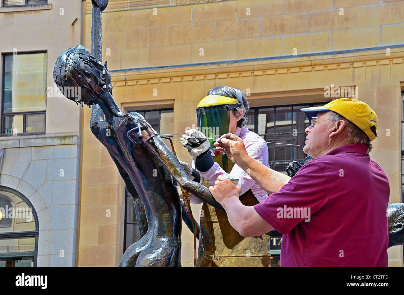 Assembling a piece of sculpture on display in Smiles Street, Ottawa