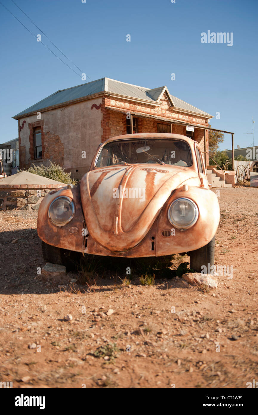 Emu face and neck painted on a vintage VW beetle parked in front of traditional homestead in the mining and film town Silverton Stock Photo