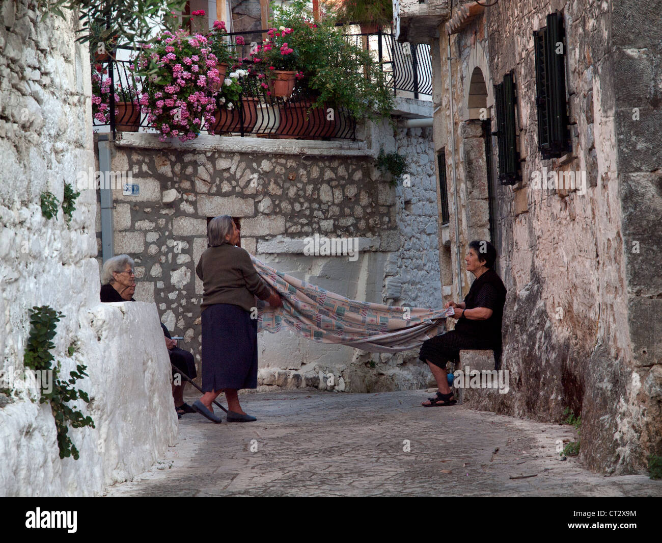 Sheet folding in the village of Pyrgos,Mani,Greece Stock Photo - Alamy