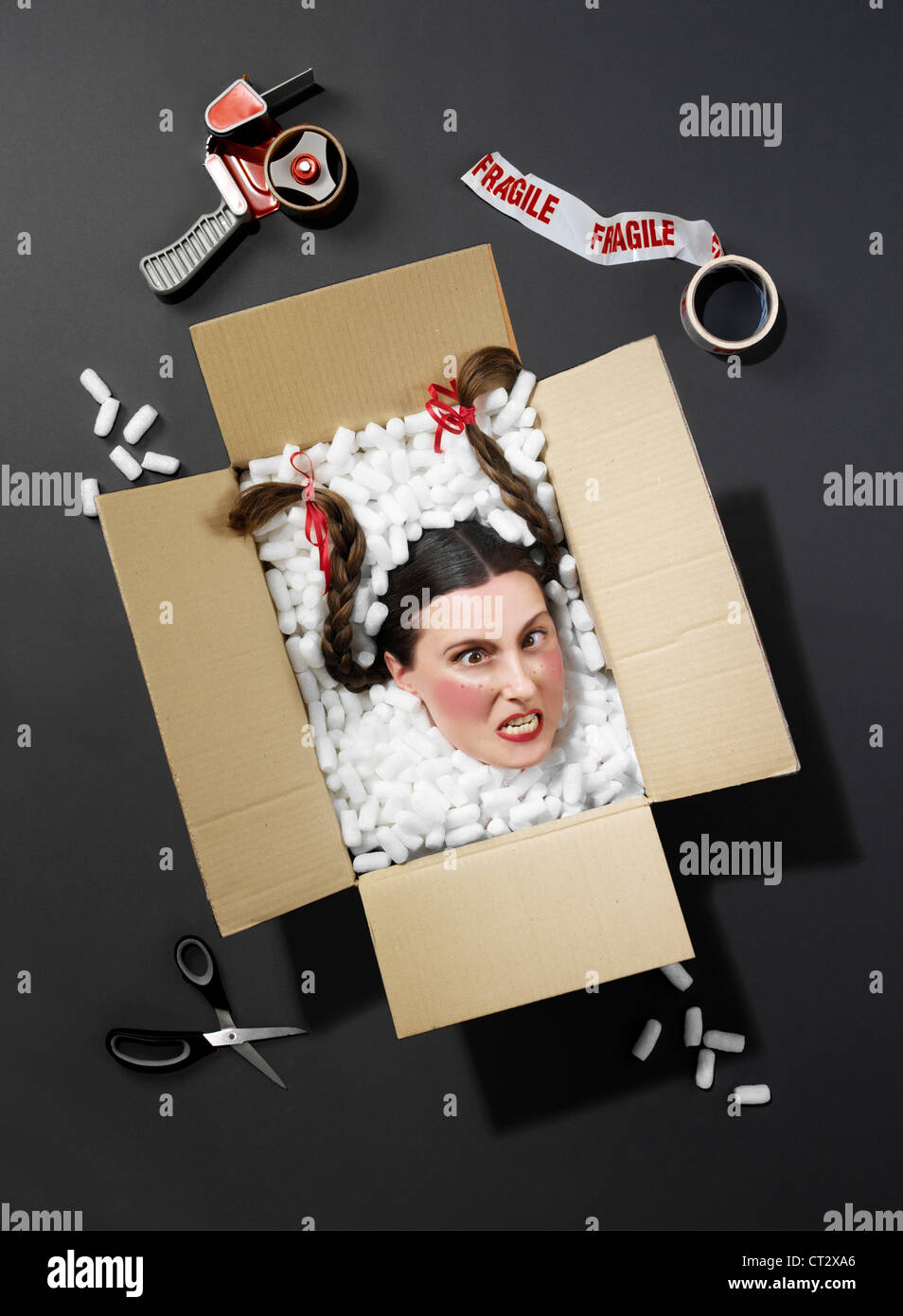 head in box surrounded by packaging Stock Photo Alamy