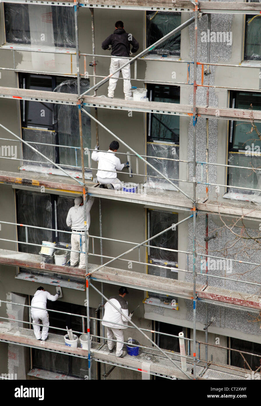 worker on a scaffolding, insulation of an apartment building. Stock Photo
