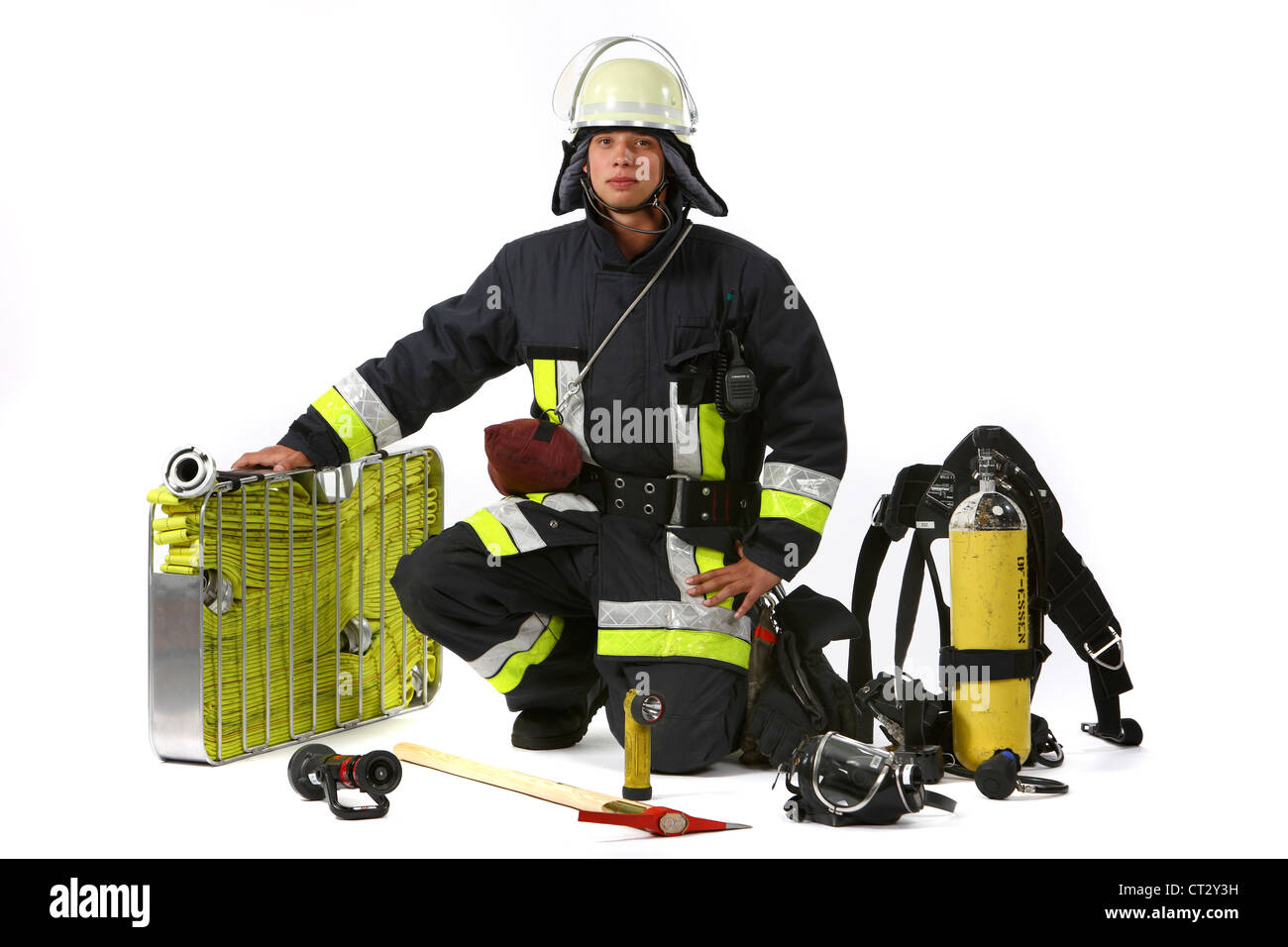 Fire men in protective, fireproof  suit, with fire fighting equipment. Fire service, fire brigade. Stock Photo