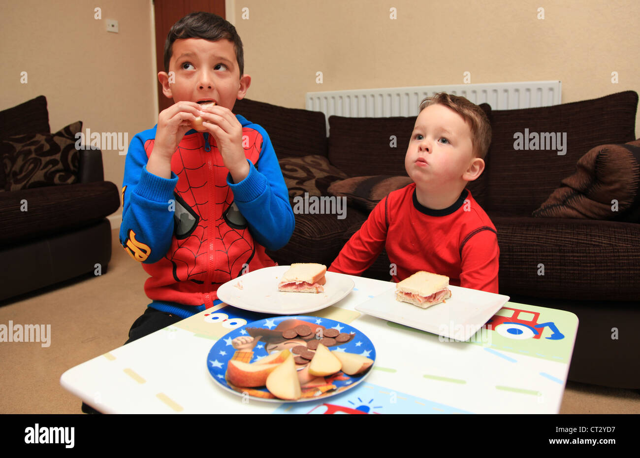 Boys eating sandwiches at home. Stock Photo