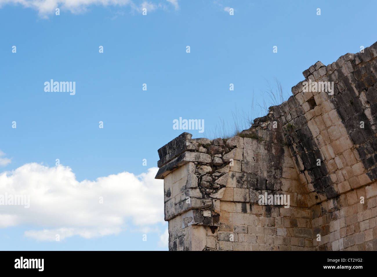 Detail of a crumbling Mayan ruin before the blue sky at Chichen Itza, Yucatan, Mexico. Stock Photo