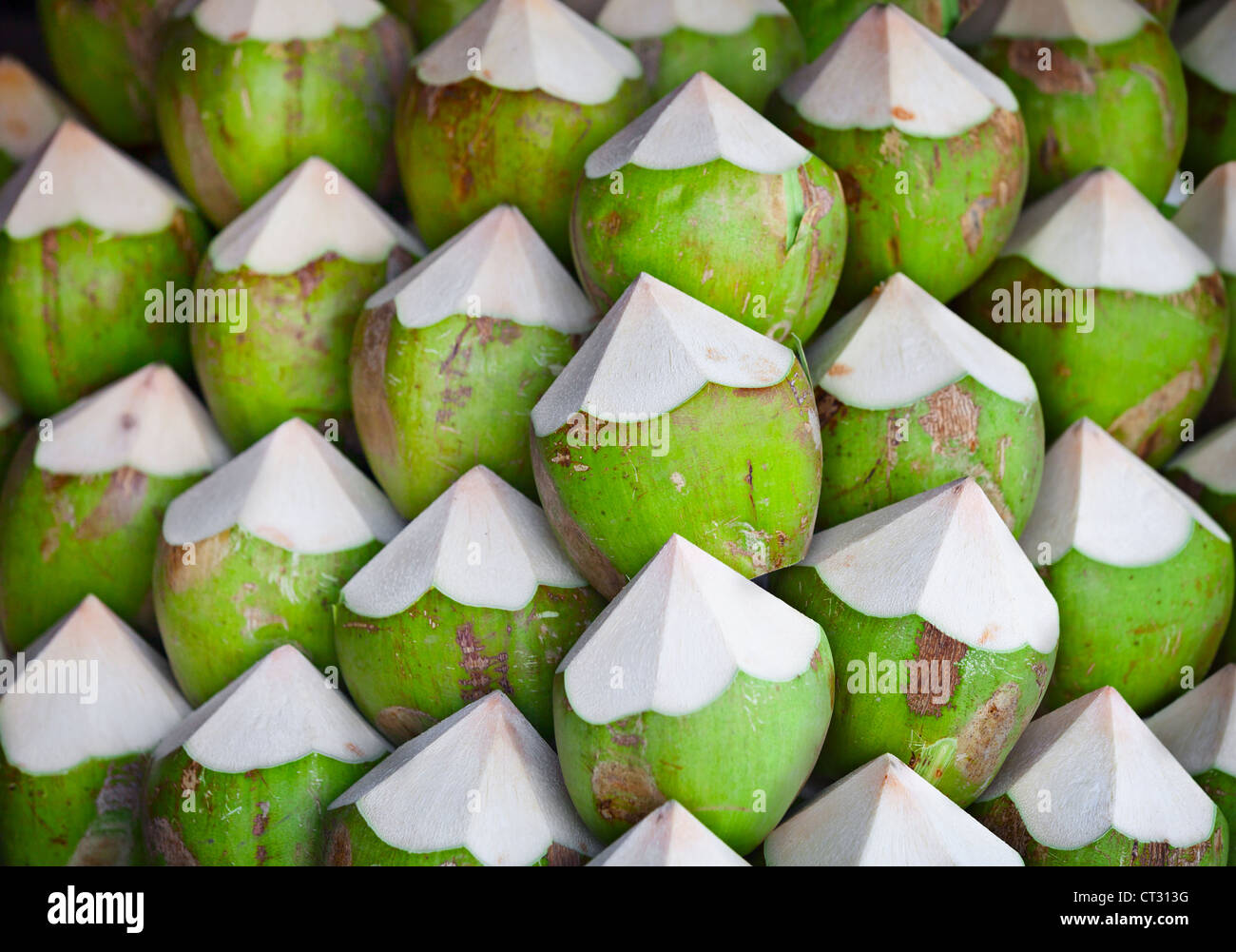 Green coconuts with juice inside, on the counter Stock Photo Alamy