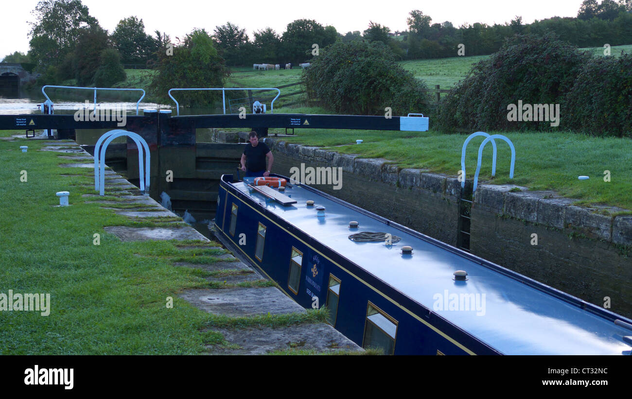 Barge boat at a lock on a canal in the autumn near Bradford-On-Avon Stock Photo