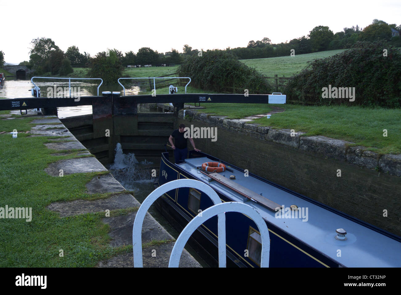 Barge boat at a lock on a canal  in the autumn near Bradford-on-Avon Stock Photo