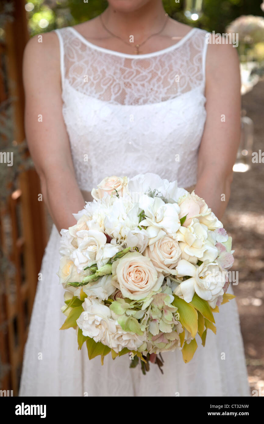 A bride is holding her bouquet of flowers. Stock Photo