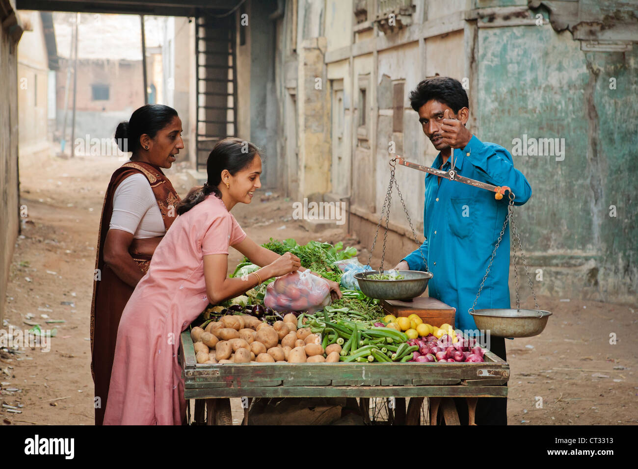 Local vegetable seller going door to door selling fresh produce, Gujarat, India Stock Photo