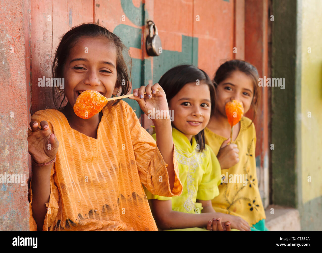 Children enjoying eating sweet lollipops, Gujarat, India Stock Photo