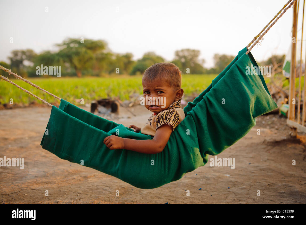 Boy In Hammock, Sejpur, Gujarat, India Stock Photo