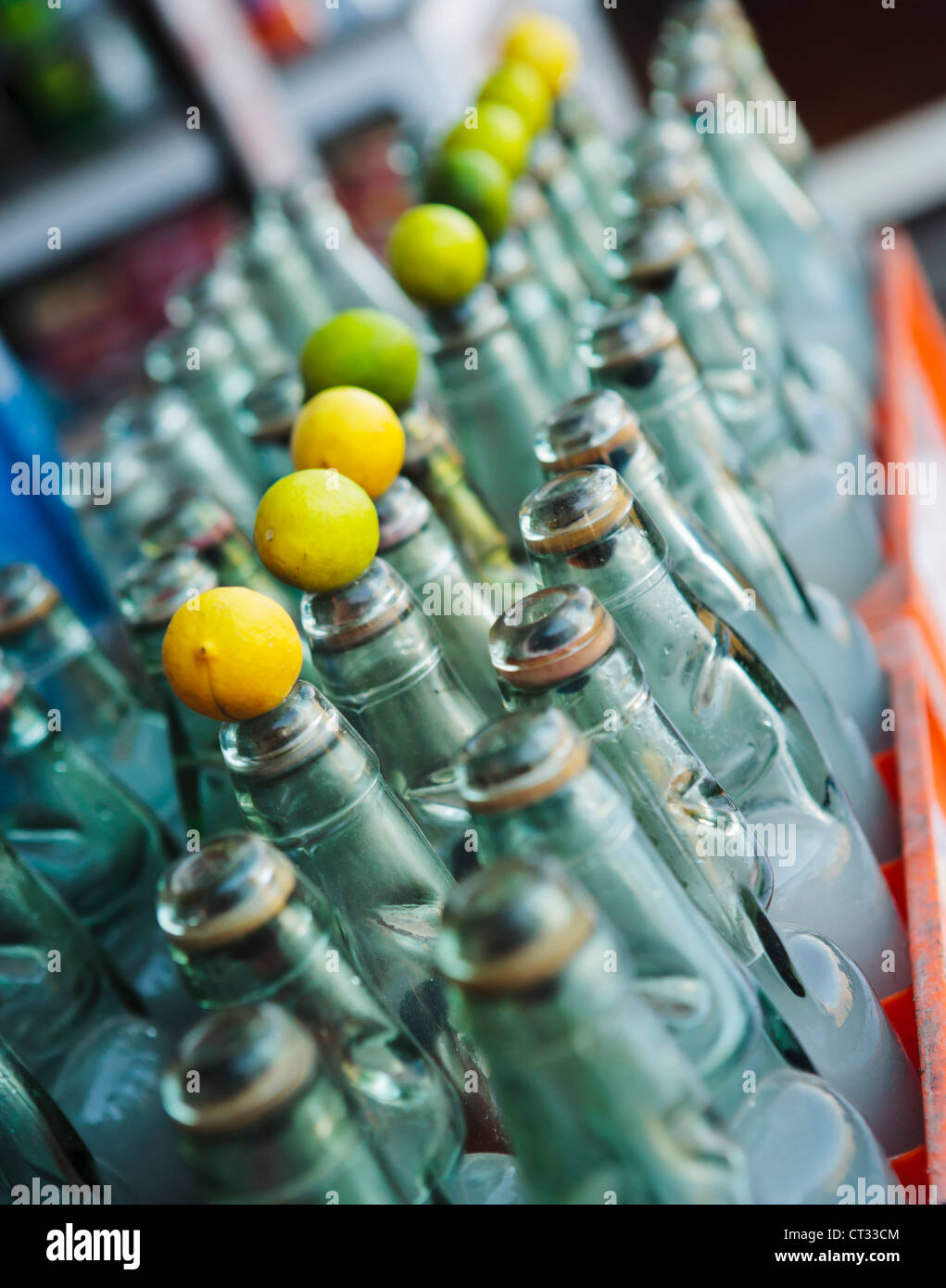 Rows of lemonade bottles with lemons on top, Himachal Pradesh, India Stock Photo