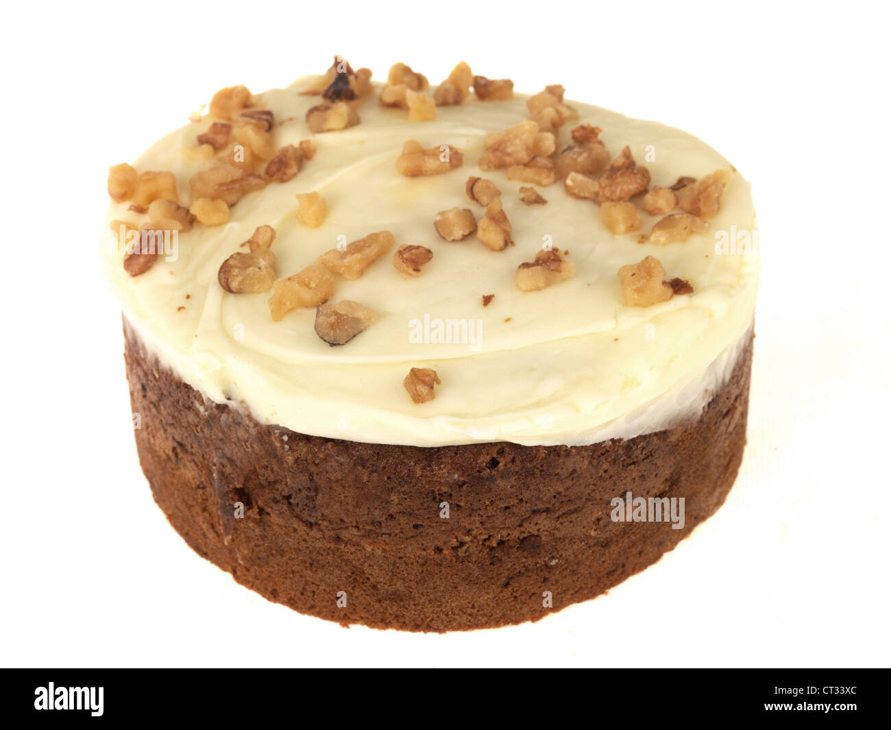 Freshly Baked And Decorated With Nuts And Icing Carrot and Walnut Cake Isolated Against A White Background With No People Stock Photo