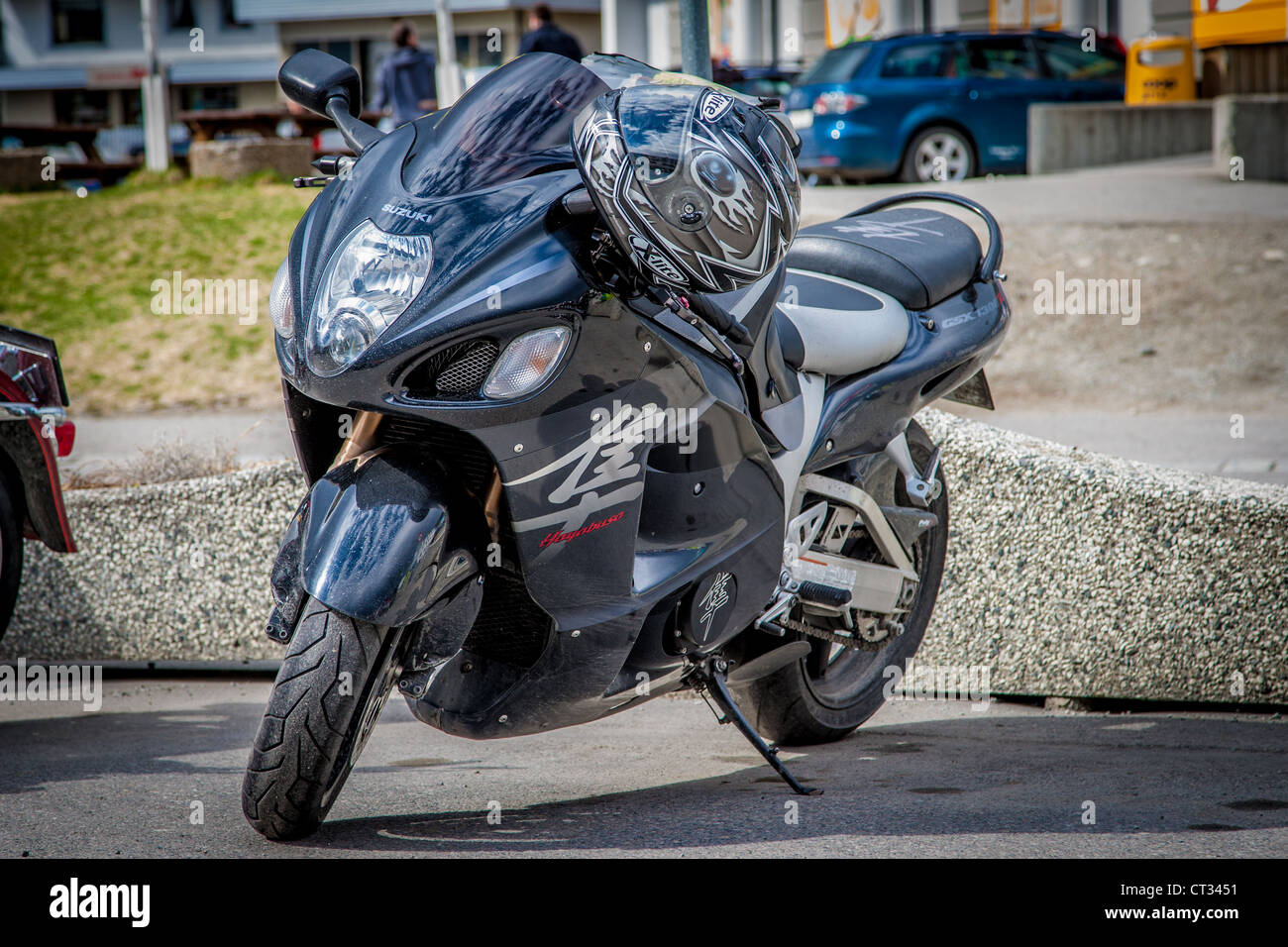 A Suzuki Hayabusa parked with a helmet in the handlebar Stock Photo