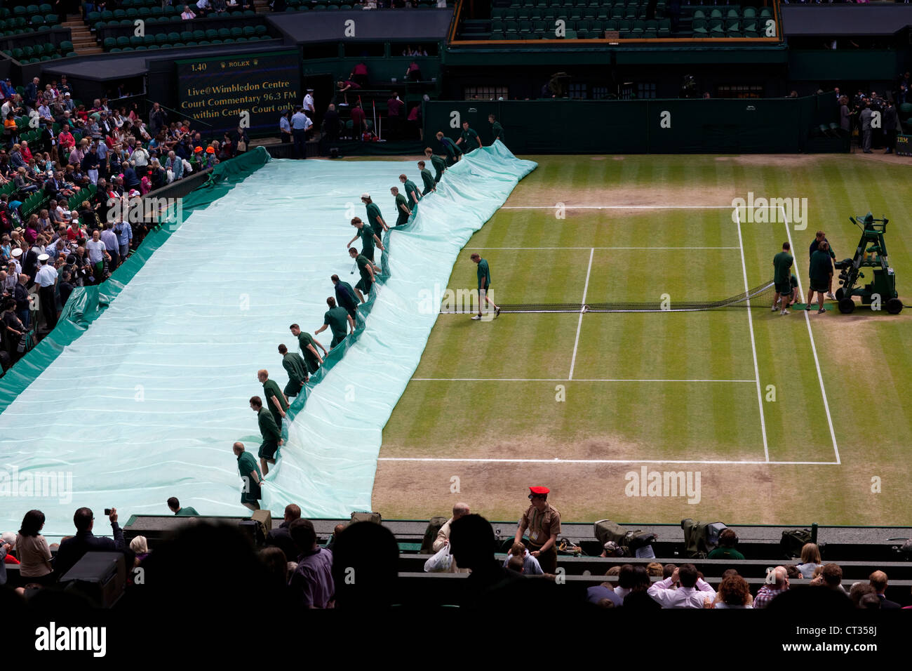 Men's Wimbledon Championship Final 2012  Andy Murray vs Roger Federer Covers on. Roof pulled over.  Third set, one set all. Stock Photo