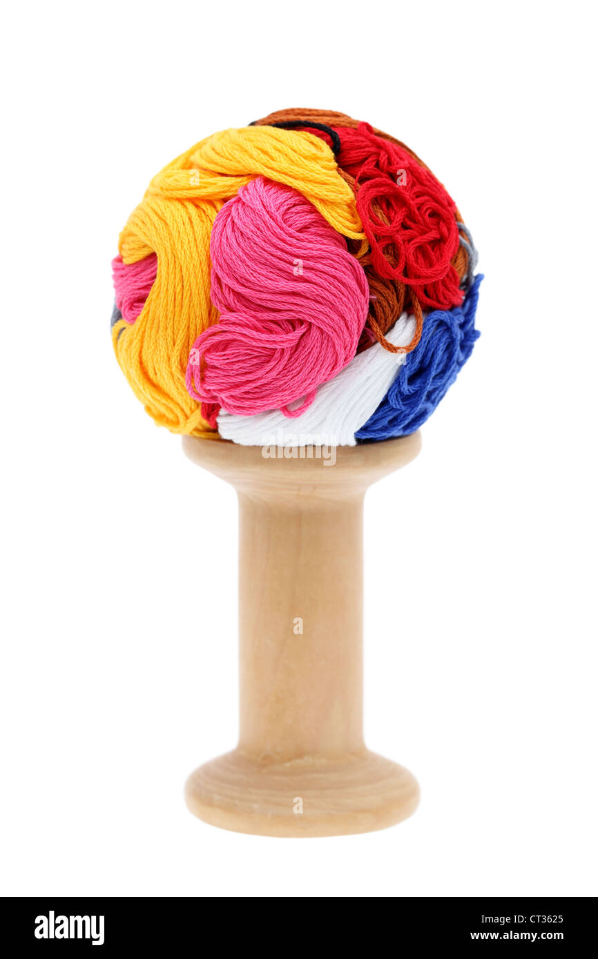 ball of colorful thread and wooden spool Stock Photo