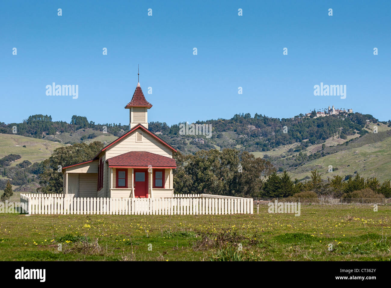 The Old San Simeon Schoolhouse in California with the famous Hearst Castle in the background. Stock Photo