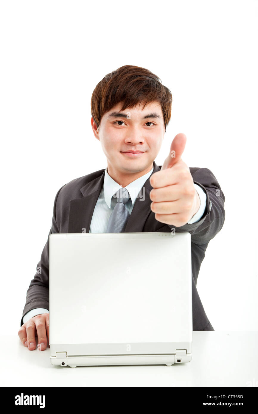 successful businessman working with computer and showing thumb up Stock Photo
