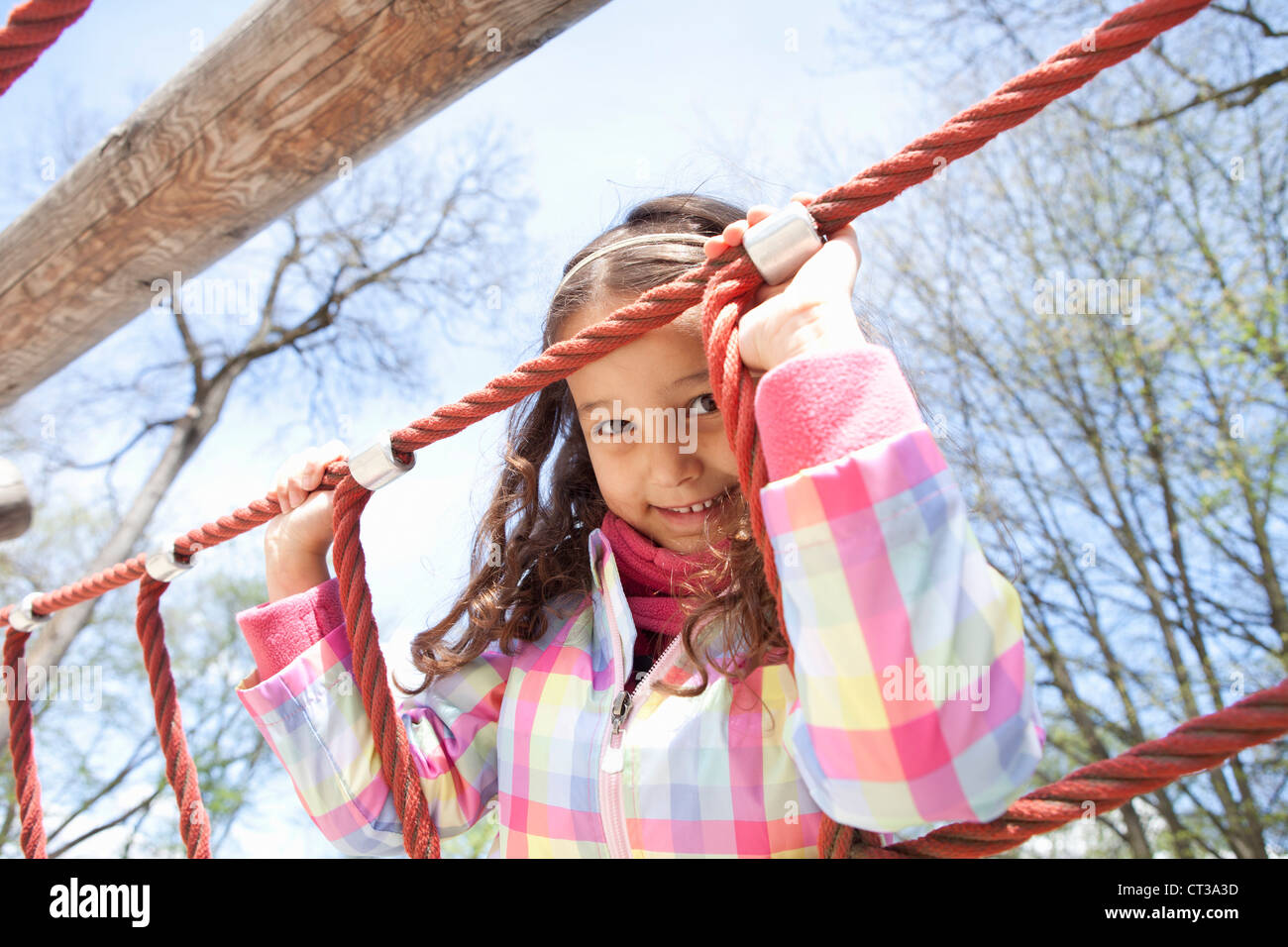 Girl climbing ropes in playground Stock Photo Alamy