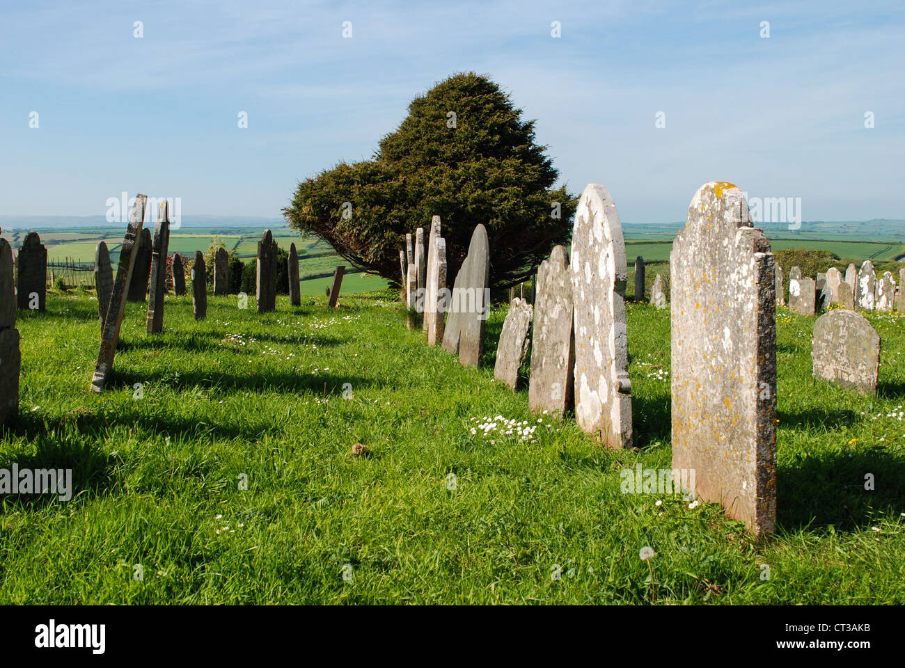 Devon Church graveyard in the rolling hills of the south hams Stock Photo
