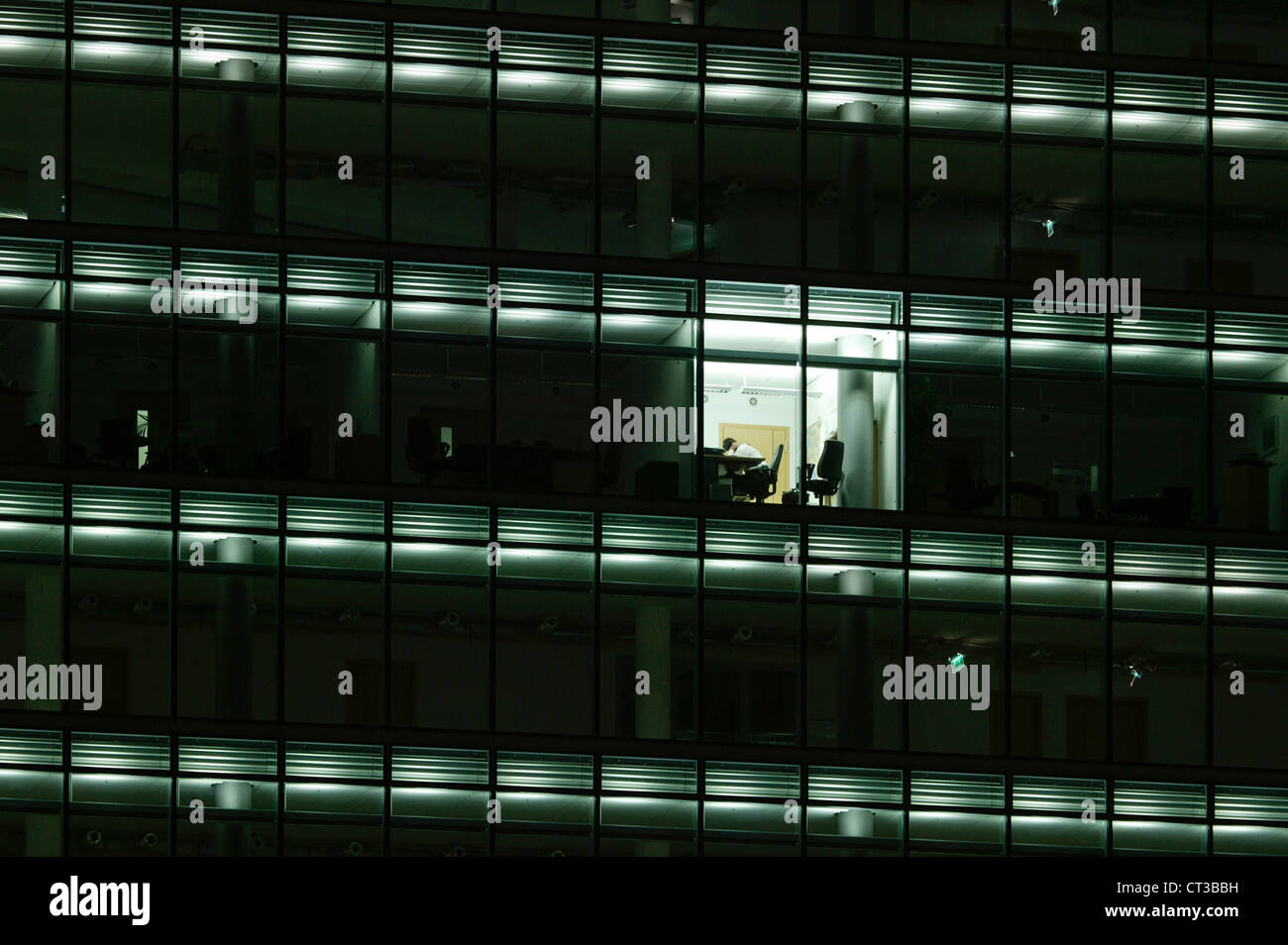 Employee does overtime at the office Stock Photo - Alamy