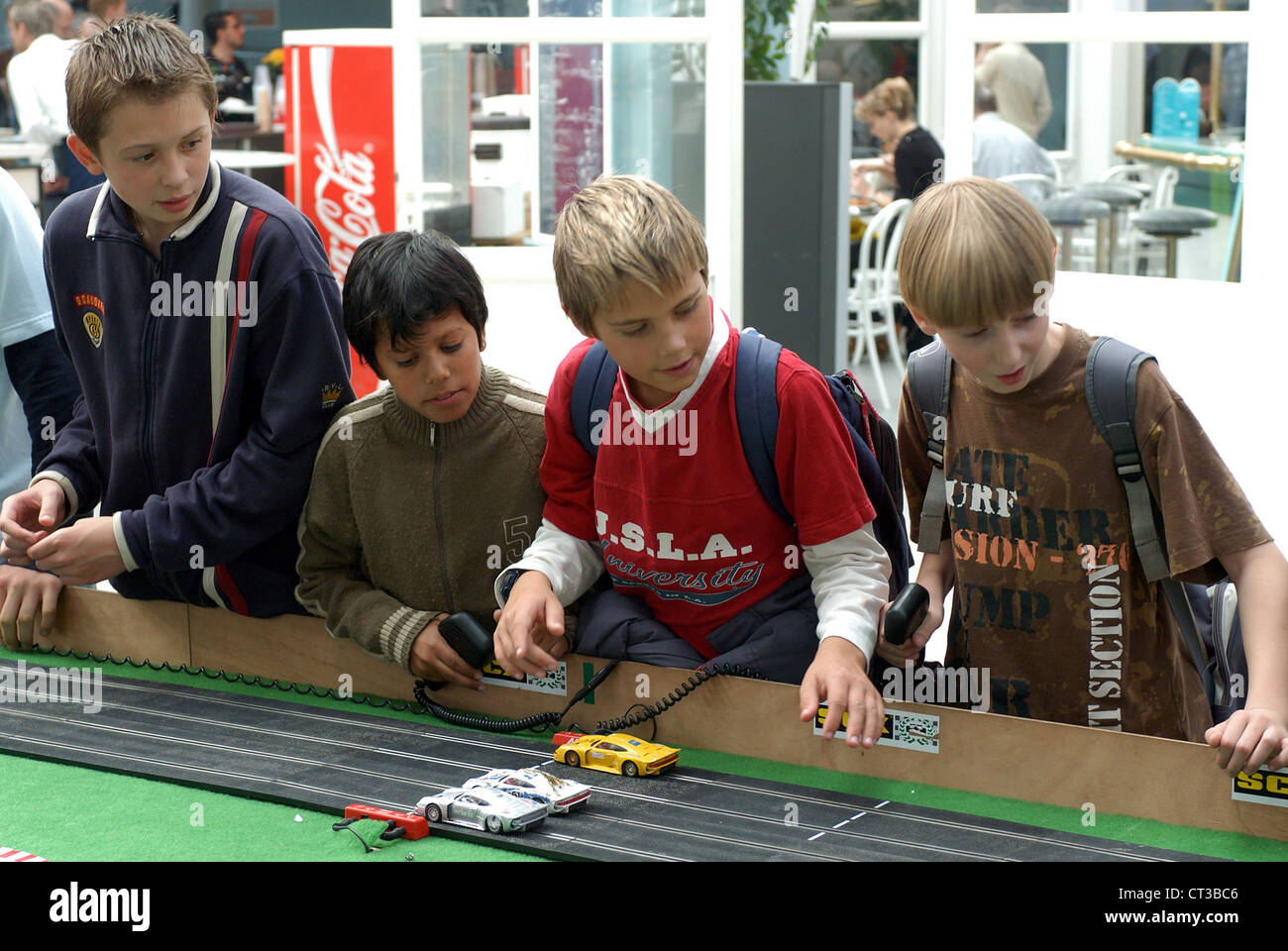 Children playing with a racetrack Stock Photo - Alamy