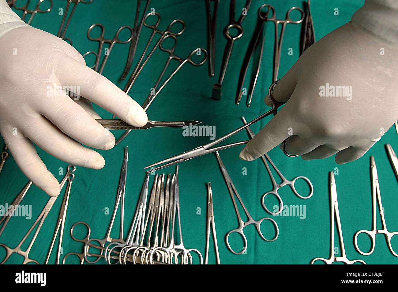 Close-up on the hands of a surgeon holding a scalpel and a pair of ...