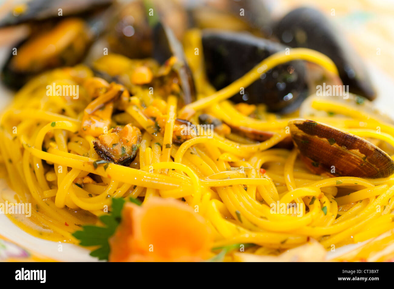 Spaghetti with mussels, clams and Saffron. Stock Photo