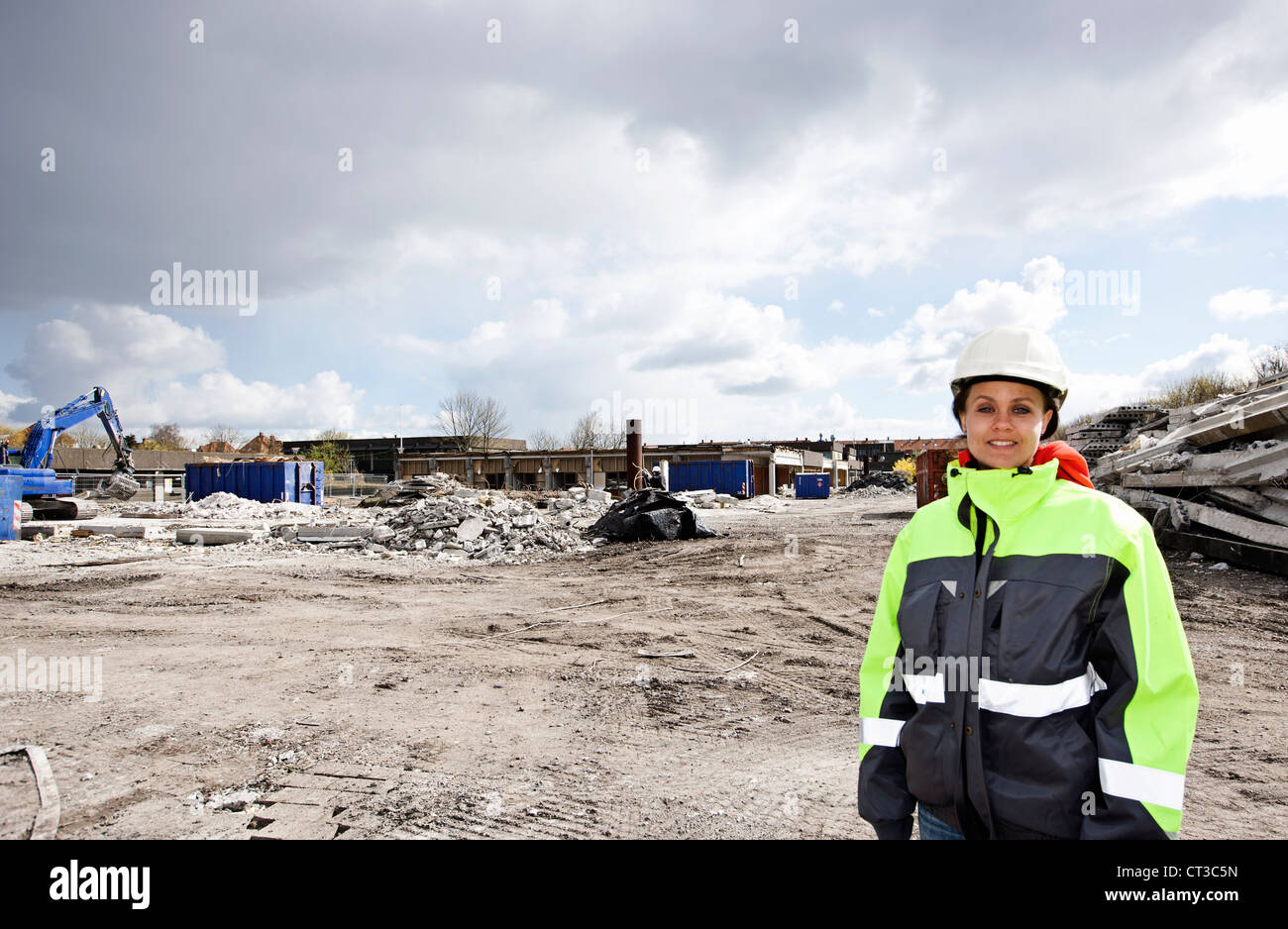 Worker standing on construction site Stock Photo - Alamy