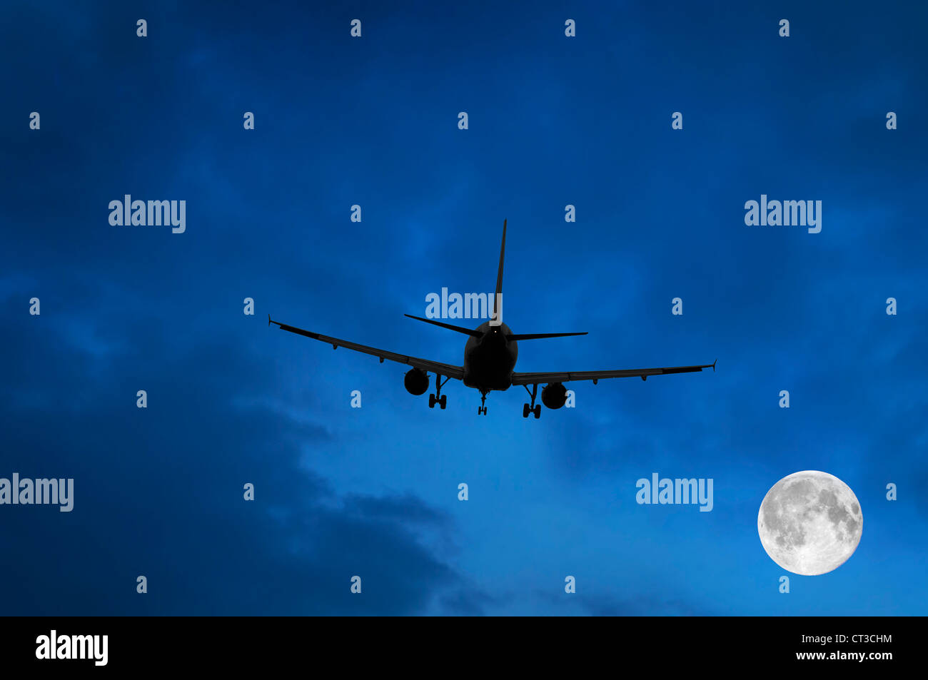 Airplane and Moon in Blue Sky Stock Photo