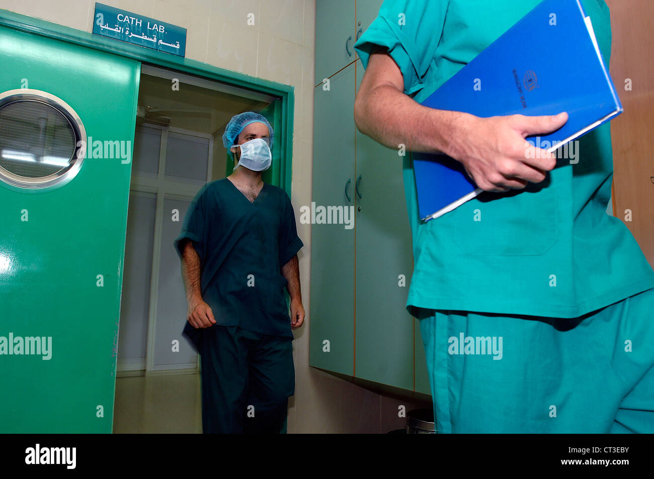 2 surgeons walking out of cardiac room Stock Photo