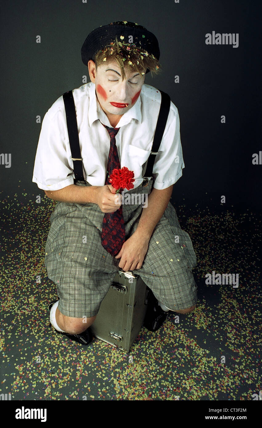 Berlin, a sad clown sitting on his suitcase Stock Photo